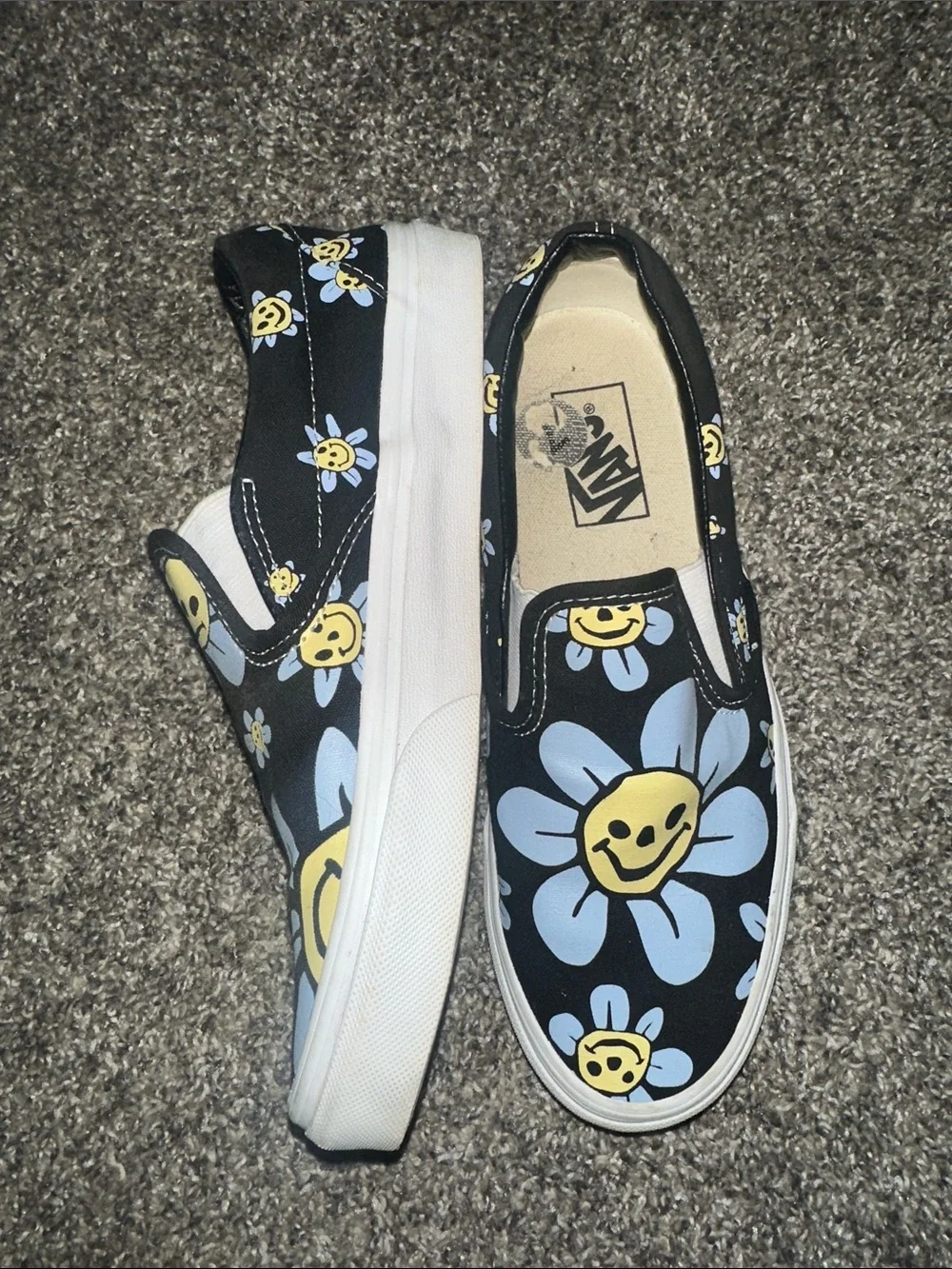 Vans Black Slip-On Sneakers with Yellow & Light Blue Daisy Smiley Print